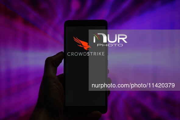 The CrowdStrike logo is being displayed on a smartphone in this photo illustration in Brussels, Belgium, on July 19, 2024. (Photo Illustrati...