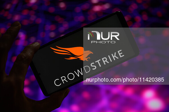 The CrowdStrike logo is being displayed on a smartphone in this photo illustration in Brussels, Belgium, on July 19, 2024. (Photo Illustrati...