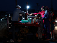 Women are purchasing snacks from a vendor in Sopore, Jammu and Kashmir, India, on July 19, 2024. (