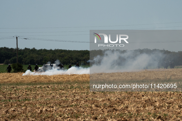 The French Gendarmerie is near a wildfire started by a launched tear gas canister during a march as part of a rally against the construction...