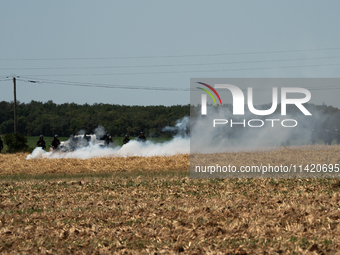 The French Gendarmerie is near a wildfire started by a launched tear gas canister during a march as part of a rally against the construction...