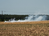 The French Gendarmerie is near a wildfire started by a launched tear gas canister during a march as part of a rally against the construction...