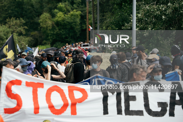 Protesters are marching during a demonstration against the construction of a giant water reservoir (mega-bassine) in Migne-Auxances, western...