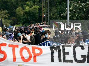 Protesters are marching during a demonstration against the construction of a giant water reservoir (mega-bassine) in Migne-Auxances, western...