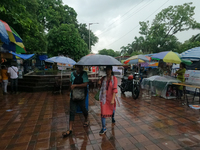 People are arriving in rain showers in Kolkata, India, on July 19, 2024. (