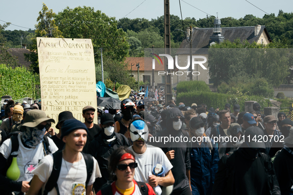 Protesters are marching during a demonstration against the construction of a giant water reservoir (mega-bassine) in Migne-Auxances, western...