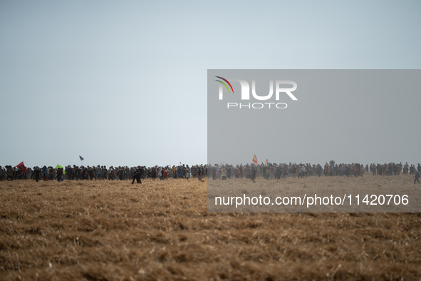 Protesters are marching during a demonstration against the construction of a giant water reservoir (mega-bassine) in Migne-Auxances, western...