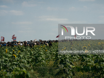 Protesters are marching during a demonstration against the construction of a giant water reservoir (mega-bassine) in Migne-Auxances, western...