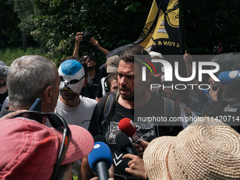 Julien Le Guet, spokesperson for the ''Bassines non merci'' collective, is speaking to a police officer during a march as part of a rally ag...