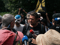 Julien Le Guet, spokesperson for the ''Bassines non merci'' collective, is speaking to a police officer during a march as part of a rally ag...