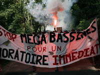 Demonstrators are holding a placard reading ''Stop the mega-basines for an immediate moratorium'' during a march as part of a rally against...