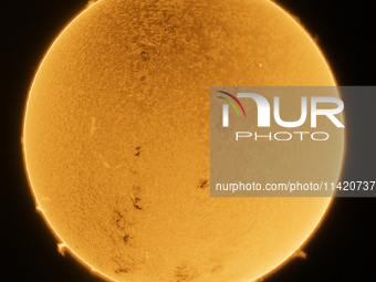 (EDITOR'S NOTE: This image was captured with an H-Alpha solar telescope and is the result of stacking 200 exposures. The final stacked image...