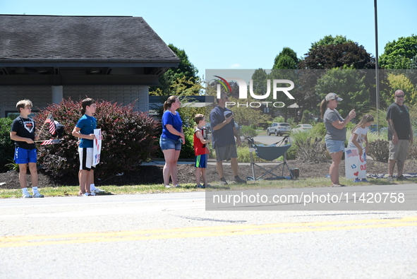 Bystanders are gathering for the funeral procession of Corey Comperatore in Sarver, Pennsylvania, United States, on July 19, 2024. Corey Com...