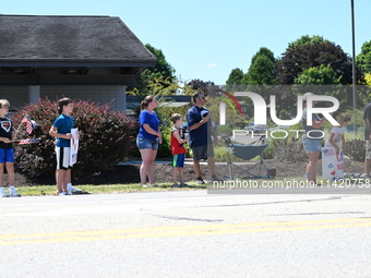 Bystanders are gathering for the funeral procession of Corey Comperatore in Sarver, Pennsylvania, United States, on July 19, 2024. Corey Com...