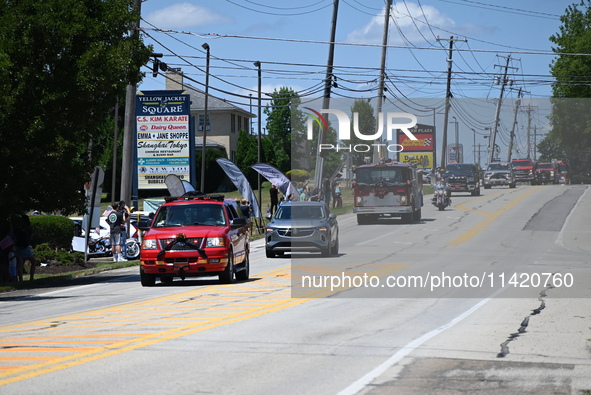 Bystanders are gathering for the funeral procession of Corey Comperatore in Sarver, Pennsylvania, United States, on July 19, 2024. The proce...