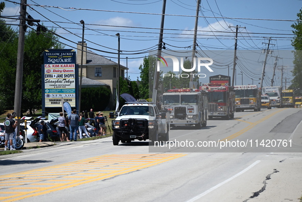 Bystanders are gathering for the funeral procession of Corey Comperatore in Sarver, Pennsylvania, United States, on July 19, 2024. The proce...