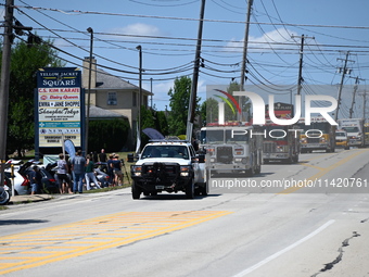 Bystanders are gathering for the funeral procession of Corey Comperatore in Sarver, Pennsylvania, United States, on July 19, 2024. The proce...