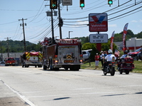 Fire trucks are at the funeral procession. Bystanders are gathering for the funeral procession of Corey Comperatore in Sarver, Pennsylvania,...