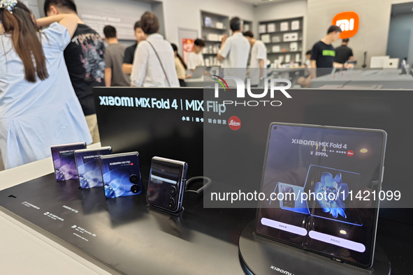 The Mi MIX Flip and MIX Fold 4 foldable phones are being displayed at the Xiaomi store in Tongling, China, on July 19, 2024. 