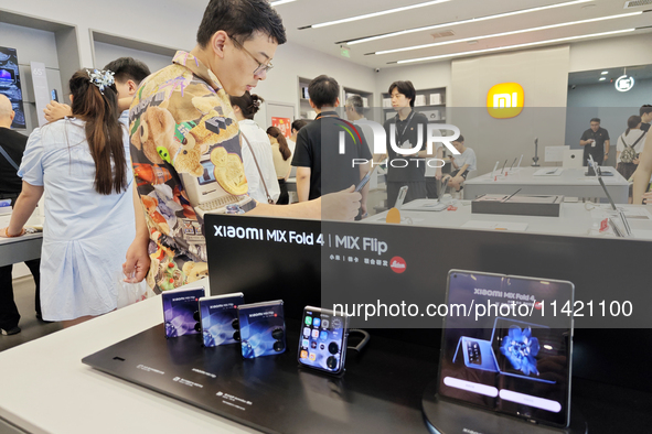 The Mi MIX Flip and MIX Fold 4 foldable phones are being displayed at the Xiaomi store in Tongling, China, on July 19, 2024. 