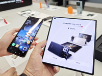 Customers are experiencing the Mi MIX Flip and MIX Fold 4 foldable phones at a Xiaomi store in Tongling, Anhui province, China, on July 19,...