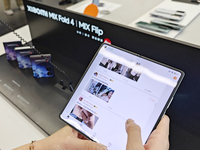 Customers are experiencing the Xiaomi MIX Fold 4 foldable screen phone at a Xiaomi store in Tongling, Anhui province, China, on July 19, 202...