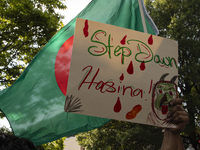 A demonstrator of the Bangladeshi community is showing a sign with the words ''Step Down Hasina'' during a rally in front of the Bangladesh...