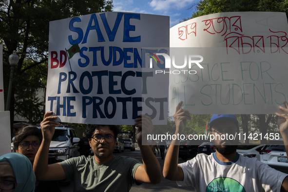 Demonstrators of the Bangladeshi community are showing signs with the words ''Justice For All Students'' among other informative texts durin...