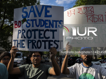 Demonstrators of the Bangladeshi community are showing signs with the words ''Justice For All Students'' among other informative texts durin...