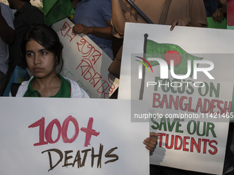 Demonstrators of the Bangladeshi community are displaying signs with the words ''100+ Deaths For What'' among other informative texts during...