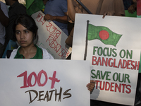 Demonstrators of the Bangladeshi community are displaying signs with the words ''100+ Deaths For What'' among other informative texts during...