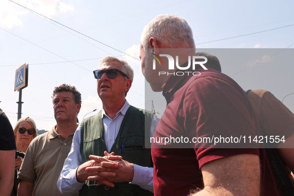 Kharkiv Mayor Ihor Terekhov and UN High Commissioner for Refugees Filippo Grandi (R to L) are being seen at the site of the aftermath of the...