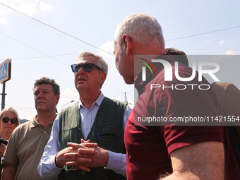 Kharkiv Mayor Ihor Terekhov and UN High Commissioner for Refugees Filippo Grandi (R to L) are being seen at the site of the aftermath of the...