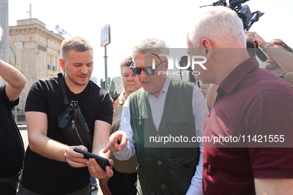 Kharkiv Mayor Ihor Terekhov and UN High Commissioner for Refugees Filippo Grandi (R to L) are being seen at the site of the aftermath of the...