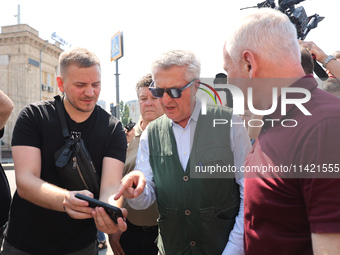 Kharkiv Mayor Ihor Terekhov and UN High Commissioner for Refugees Filippo Grandi (R to L) are being seen at the site of the aftermath of the...