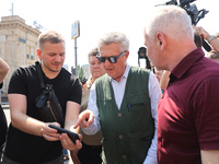 Kharkiv Mayor Ihor Terekhov and UN High Commissioner for Refugees Filippo Grandi (R to L) are being seen at the site of the aftermath of the...