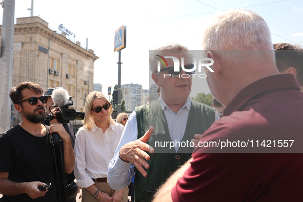 Kharkiv Mayor Ihor Terekhov and UN High Commissioner for Refugees Filippo Grandi (R to L) are being seen at the site of the aftermath of the...