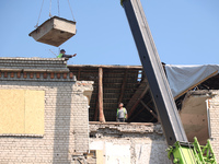 Workers are responding to the aftermath of a Russian missile attack on a residential apartment building in Kharkiv, Ukraine, on July 17, 202...