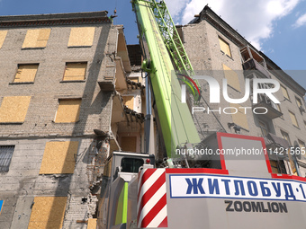 Special equipment is being seen during the response to the aftermath of a Russian missile attack on a residential apartment building in Khar...