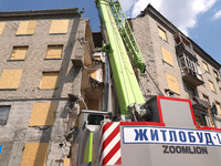 Special equipment is being seen during the response to the aftermath of a Russian missile attack on a residential apartment building in Khar...