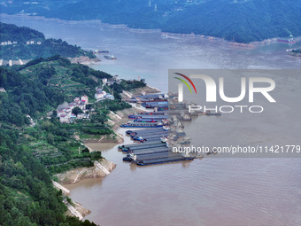 Ships are docking in the upstream waters of the Three Gorges Dam after the water level has dropped and are waiting to pass through the sluic...