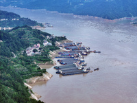 Ships are docking in the upstream waters of the Three Gorges Dam after the water level has dropped and are waiting to pass through the sluic...