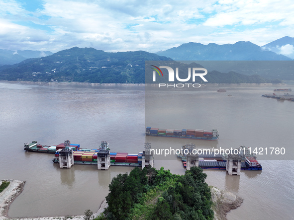 Ships are docking in the upstream waters of the Three Gorges Dam after the water level has dropped and are waiting to pass through the sluic...