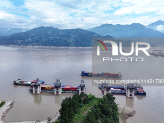 Ships are docking in the upstream waters of the Three Gorges Dam after the water level has dropped and are waiting to pass through the sluic...