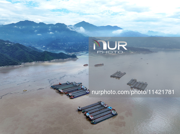 Ships are docking in the upstream waters of the Three Gorges Dam after the water level has dropped and are waiting to pass through the sluic...