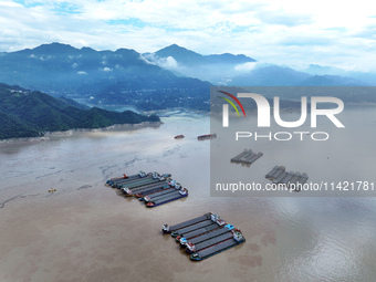 Ships are docking in the upstream waters of the Three Gorges Dam after the water level has dropped and are waiting to pass through the sluic...