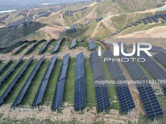 The barren mountains of the past are now filling with solar photovoltaics in Li Mawu Village, Yuncheng City, Shanxi Province, China, on July...