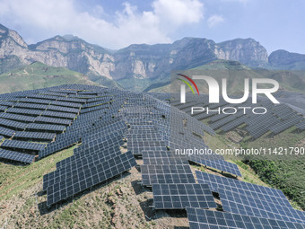 The barren mountains of the past are now filling with solar photovoltaics in Li Mawu Village, Yuncheng City, Shanxi Province, China, on July...