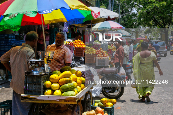 Merchants are selling fruits from small carts along the roadside in the East Fort in Thiruvananthapuram (Trivandrum), Kerala, India, on Apri...