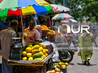 Merchants are selling fruits from small carts along the roadside in the East Fort in Thiruvananthapuram (Trivandrum), Kerala, India, on Apri...